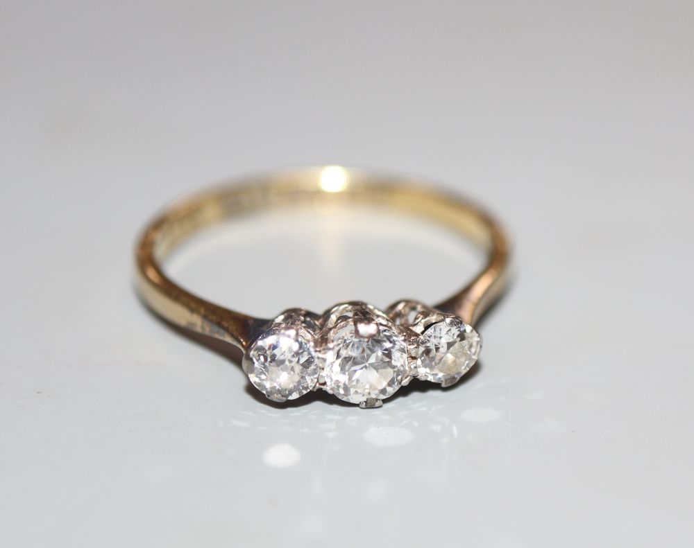 A mid 20th century 18ct and plat, three stone diamond ring, size N, gross 2.3 grams.